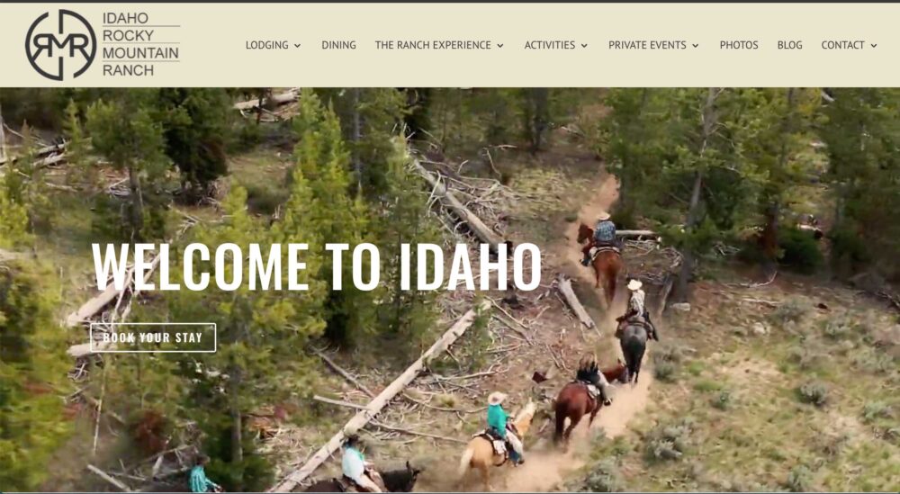 A screenshot of the Idaho Rocky Mountain Ranch website homepage with guests riding horses in an aerial view.